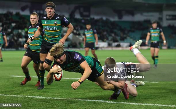 Henry Pollock of Northampton Saints dives over for their fourth try during the Premiership Rugby Cup match between Northampton Saints and Saracens at...