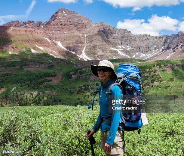 mature woman backpacker in front of the maroon bells west side. four pass backpacking trip around the maroon bells. aspen, colorado. - maroon bells summer stock pictures, royalty-free photos & images