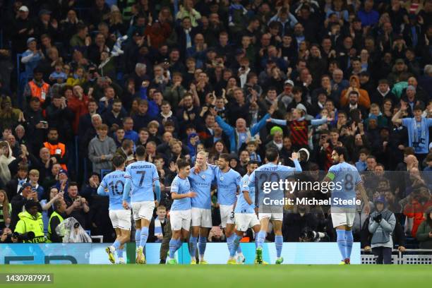 Erling Haaland celebrates with Julian Alvarez and Ruben Dias of Manchester City after scoring their team's second goal during the UEFA Champions...