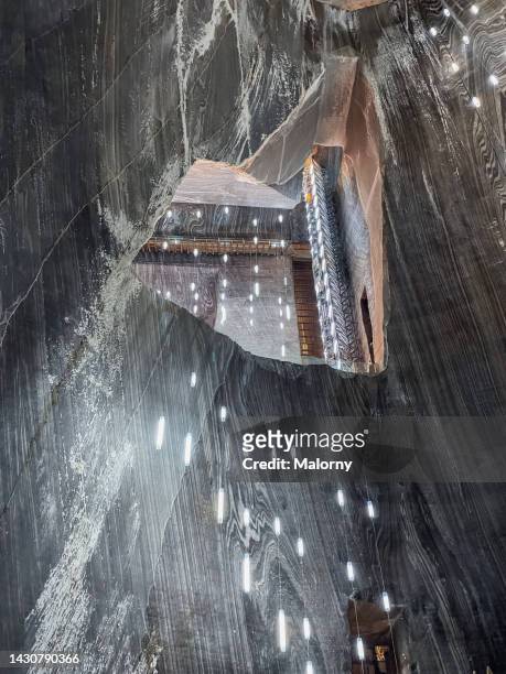 futuristic lights hanging from the ceiling of a mine or cave. symbolizing power, resources and technology in a near future - mine elevator stock pictures, royalty-free photos & images