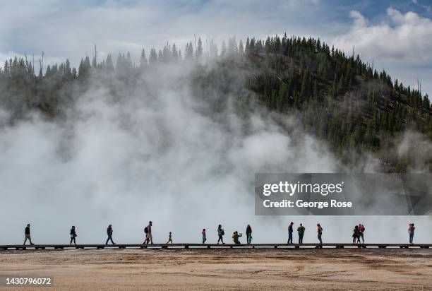 Visitors walk along a boardwalk at the iconic Grand Prismatic Spring in Yellowstone National Park's Midway Geyser Basin on September 18 in...
