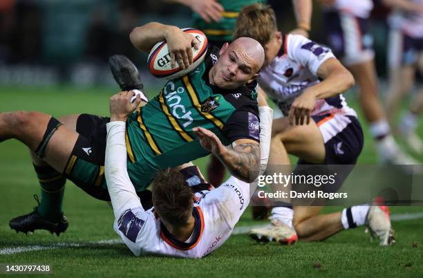 Aaron Hinkley of Northampton Saints dives over to score their ninth try during the Premiership Rugby Cup match between Northampton Saints and...