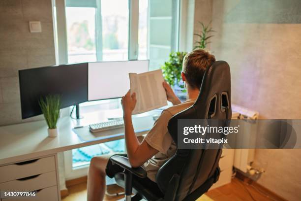 teenager boy studying at home - one teenage boy only stock pictures, royalty-free photos & images