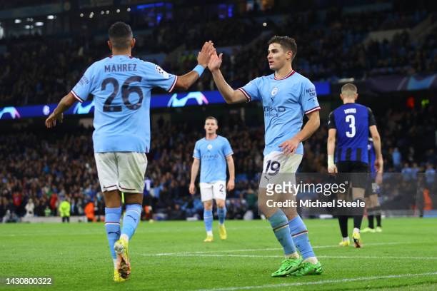 Julian Alvarez celebrates with Riyad Mahrez of Manchester City after scoring their team's fifth goal during the UEFA Champions League group G match...