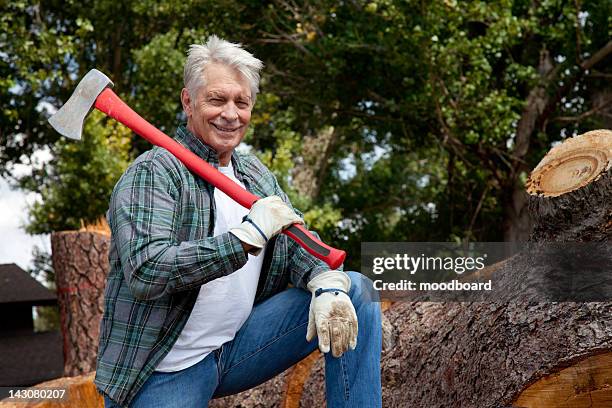 portrait of lumberjack holding an axe - lumberjack stock pictures, royalty-free photos & images