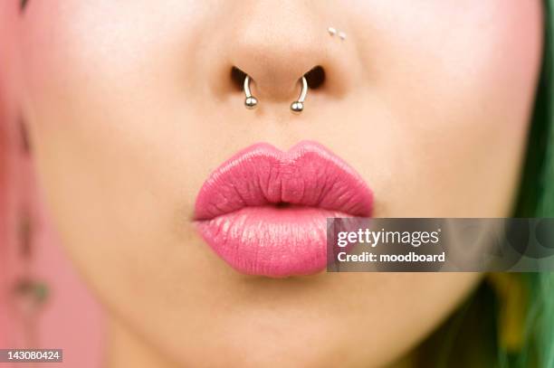 young woman puckering her lips - piercing stock-fotos und bilder