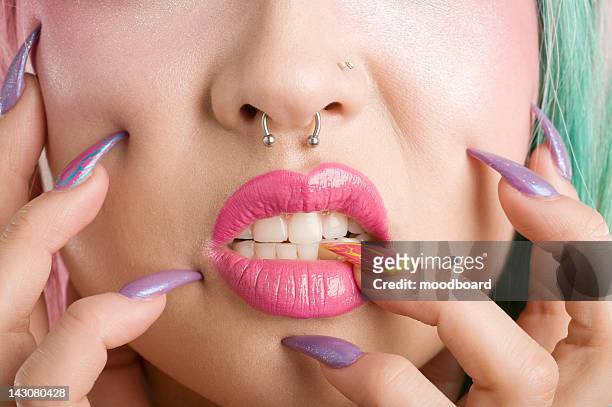 close-up of a woman's mouth and fingers - nose piercing - fotografias e filmes do acervo