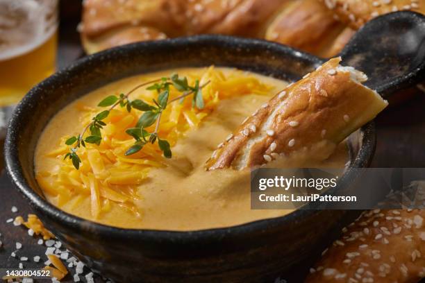 beer cheese sauce with soft pretzels - cheese sauce stock pictures, royalty-free photos & images