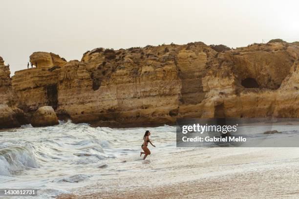 young woman at the beach in albufeira - albufeira beach stockfoto's en -beelden