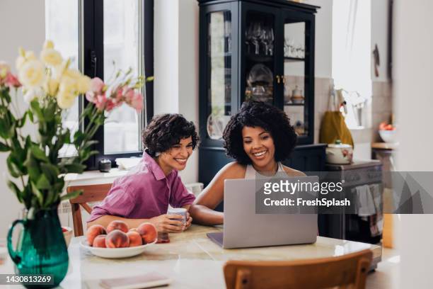two happy businesswomen working together from home on their comp - life coach stock pictures, royalty-free photos & images