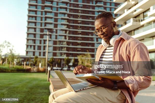 young man sitting on the bench and learning - reading glasses isolated stock pictures, royalty-free photos & images