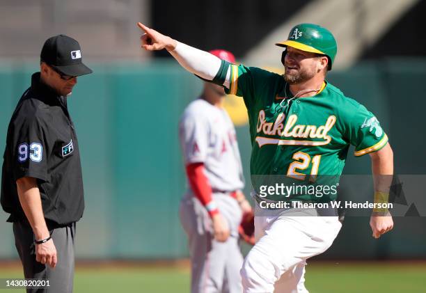 Stephen Vogt of the Oakland Athletics celebrates while trotting around the bases after hitting a solo home run against the Los Angeles Angels in the...