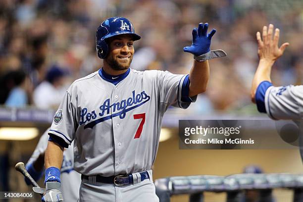 Milwaukee, WI James Loney of the Los Angeles Dodgers high fives Mark Ellis after scoring the Dodgers first run against the Milwaukee Brewers during...