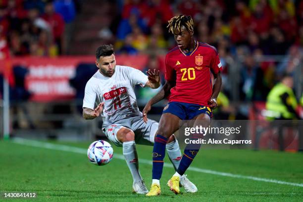 Nicholas 'Nico' Williams Arthuer of Spain passes is challenged by Renato Steffen of Switzerland during the UEFA Nations League League A Group 2 match...