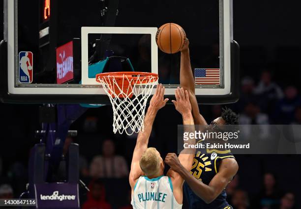 Mason Plumlee of the Charlotte Hornets blocks a dunk by Jalen Smith of the Indiana Pacers in the first quarter during a preseason game at Spectrum...