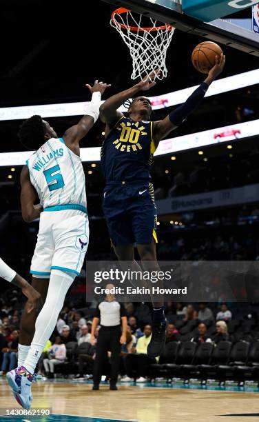 Bennedict Mathurin of the Indiana Pacers goes for a layup around Mark Williams of the Charlotte Hornets in the fourth quarter during a preseason game...