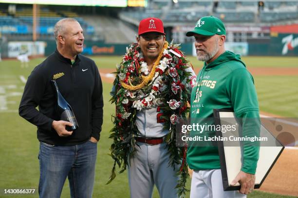 Retiring Los Angeles Angels player Kurt Suzuki is presented with gift before the game against his former team, the Oakland Athletics, at RingCentral...