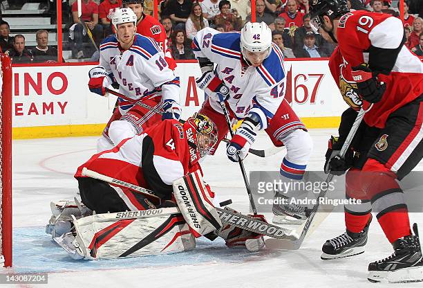 Craig Anderson of the Ottawa Senators makes a save against Artem Anisimov of the New York Rangers as Jason Spezza of the Ottawa Senators and Marc...