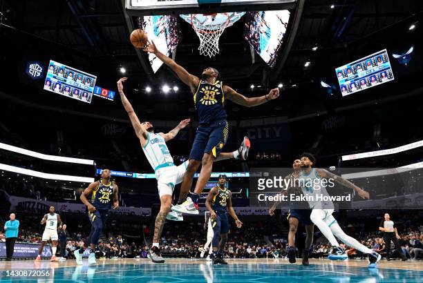 Myles Turner of the Indiana Pacers blocks a layup by James Bouknight of the Charlotte Hornets in the second quarter during a preseason game at...