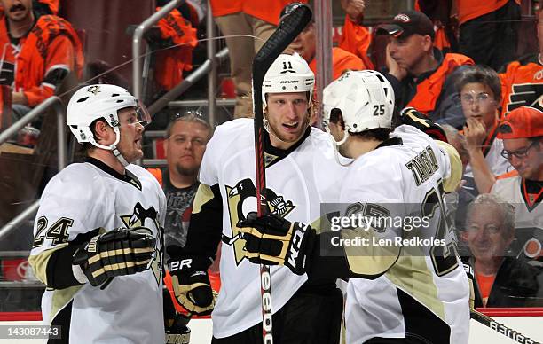 Matt Cooke, Jordan Staal, and Eric Tangradi of the Pittsburgh Penguins celebrate Staal's third goal of the game against the Philadelphia Flyers in...