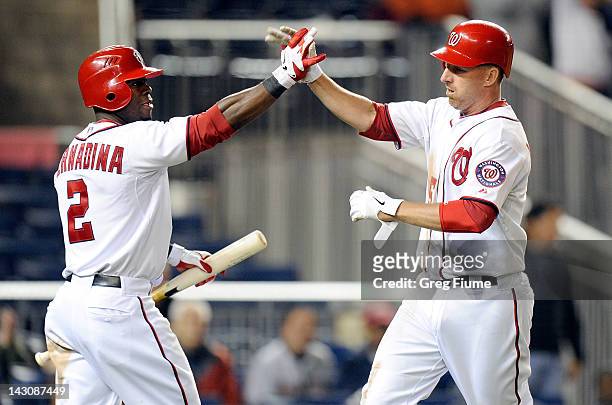 Adam LaRoche of the Washington Nationals celebrates with Roger Bernadina after scoring the game winning run in the eighth inning against the Houston...