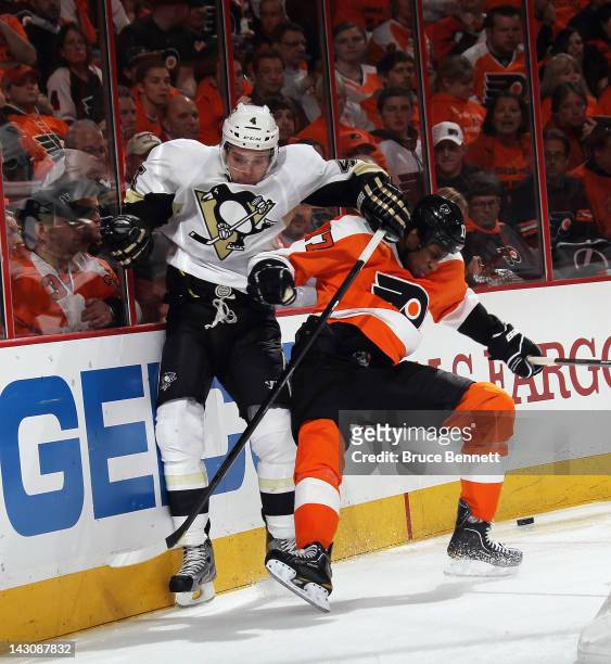 Wayne Simmonds of the Philadelphia Flyers bounces off Zbynek Michalek of the Pittsburgh Penguins in Game Four of the Eastern Conference Quarterfinals...