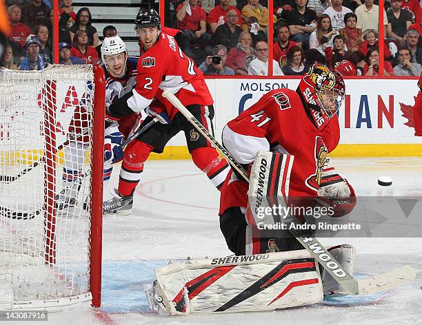 Craig Anderson of the Ottawa Senators makes a save as teammate Jared Cowen defends against Derek Stepan of the New York Rangers in Game Four of the...