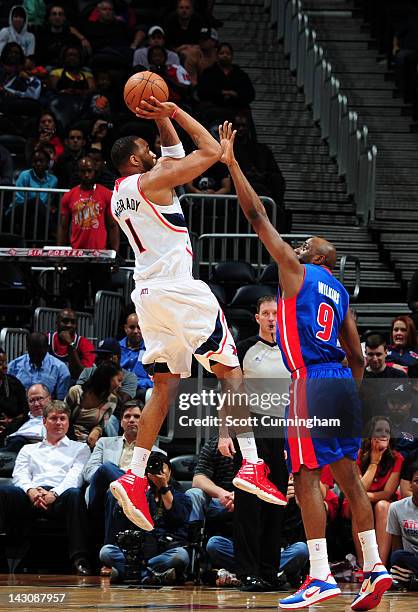 Tracy McGrady of the Atlanta Hawks shoots against Damien Wilkins of the Detroit Pistons on April 18, 2012 at Philips Arena in Atlanta, Georgia. NOTE...