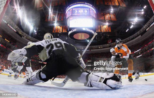 Marc-Andre Fleury of the Pittsburgh Penguins slides over and kicks the puck away from Jaromir Jagr of the Philadelphia Flyers in Game Four of the...