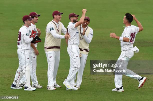 Michael Neser and James Bazley of Queensland celebrate the wicket of Jake Doran of Tasmania during the Sheffield Shield match between Queensland...