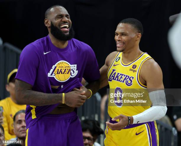 LeBron James and Russell Westbrook of the Los Angeles Lakers laugh on the sideline after Westbrook was called for a technical foul on the bench in...
