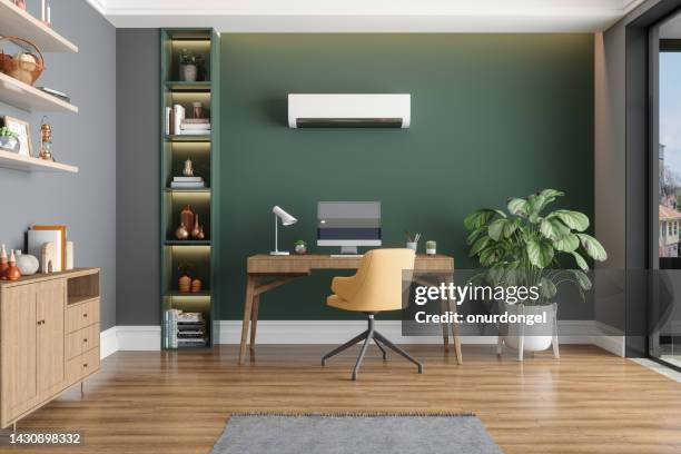 home office interior with air conditioner, table, desktop computer and wooden cabinet - office minimalist stockfoto's en -beelden