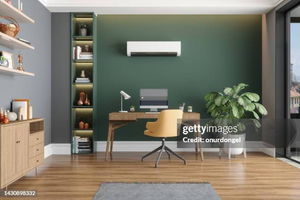 home office interior with air conditioner, table, desktop computer and wooden cabinet - cool desktop stock pictures, royalty-free photos & images