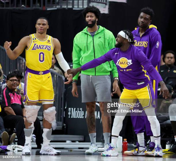 Patrick Beverley of the Los Angeles Lakers jokingly tries to hold teammate Russell Westbrook back as Anthony Davis and Thomas Bryant of the Lakers...