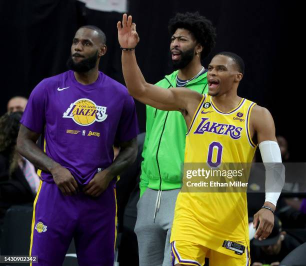 LeBron James, Anthony Davis and Russell Westbrook of the Los Angeles Lakers react on the sideline in the fourth quarter of their preseason game...