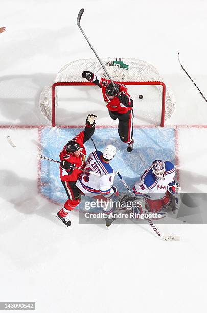 Kyle Turris and Chris Neil of the Ottawa Senators celebrate a second period goal against Michael Del Zotto and Henrik Lundqvist of the New York...