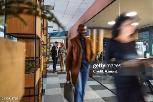 blurred people moving through office - corporate culture stock pictures, royalty-free photos & images