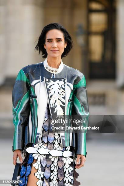 Jennifer Connelly wears a black / green / white shiny leather embroidered yoke jacket from Louis Vuitton, a white / purple and blue tie and dye print...