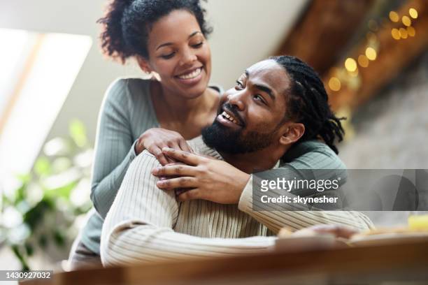happy black couple talking during morning at home. - happy couple stockfoto's en -beelden