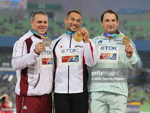 Silver medalist Krisztian Pars of Hungary, gold medalist Koji Murofushi of Japan and bronze medalist Primoz Kozmus of Slovenia attends the victory...