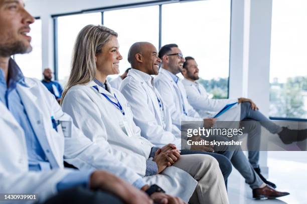 happy medical experts attending an education event in board room. - attendee stock pictures, royalty-free photos & images