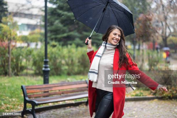 young woman enjoying rainy weather - rain model stockfoto's en -beelden