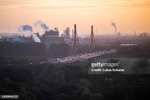 Cars cross a bridge while steem rises up from the ThyssenKrupp steel factory on October 06, 2022 in Duisburg, Germany. The German economy, and German...