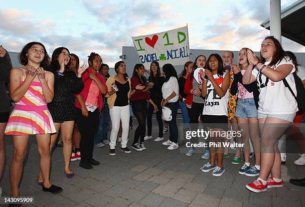 One Direction fans wait at Auckland International Airport for the arrival of the band on April 19, 2012 in Auckland, New Zealand. One Direction...