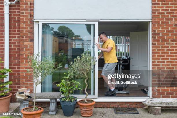 setting up a home workout - opening sliding doors stock pictures, royalty-free photos & images