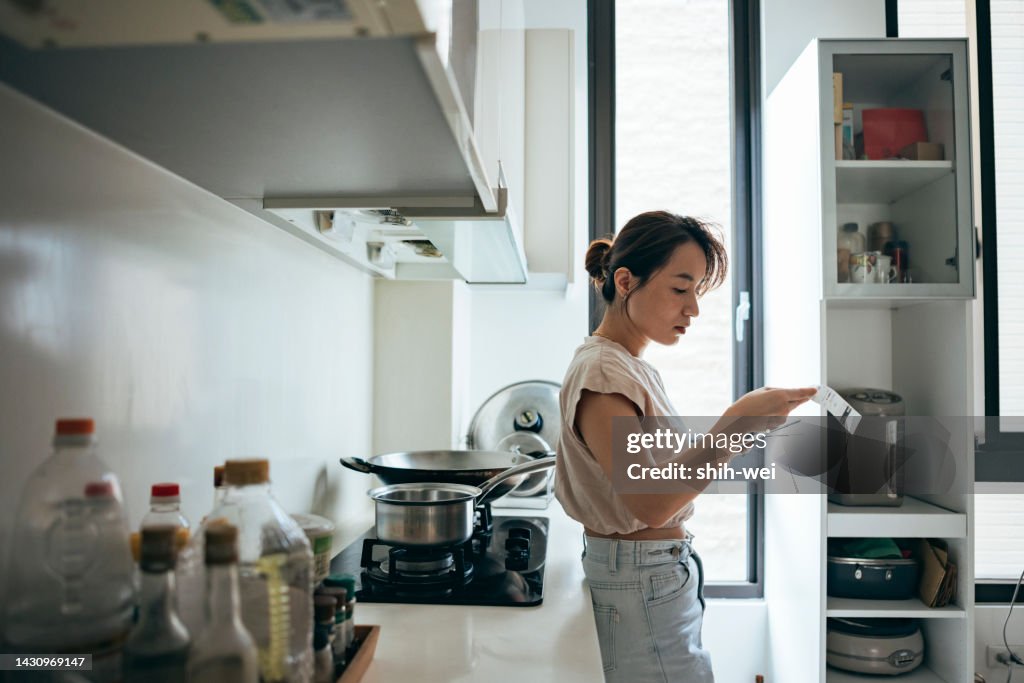 Asian women examining the shopping receipt at home