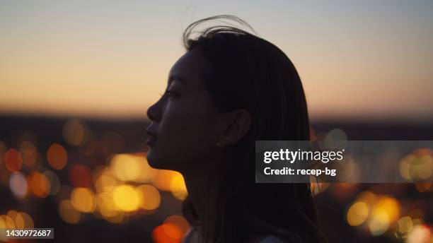 portrait of young woman on top of cliff in nature - desert sky stock pictures, royalty-free photos & images