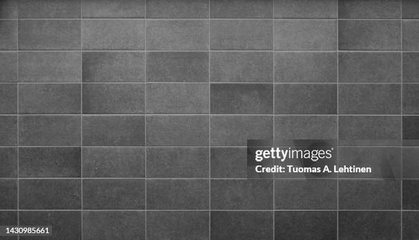 front view of a new and modern wall or building exterior made of gray slabs. - tiled wall stock pictures, royalty-free photos & images