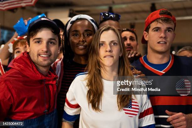 group of young soccer fans watching usa national team game at crowded sports bar - crowd cheering bar stock pictures, royalty-free photos & images