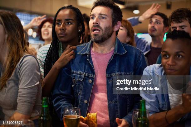group of young friends having fun and cheering for favorite team at sports bar - crowd cheering bar stock pictures, royalty-free photos & images